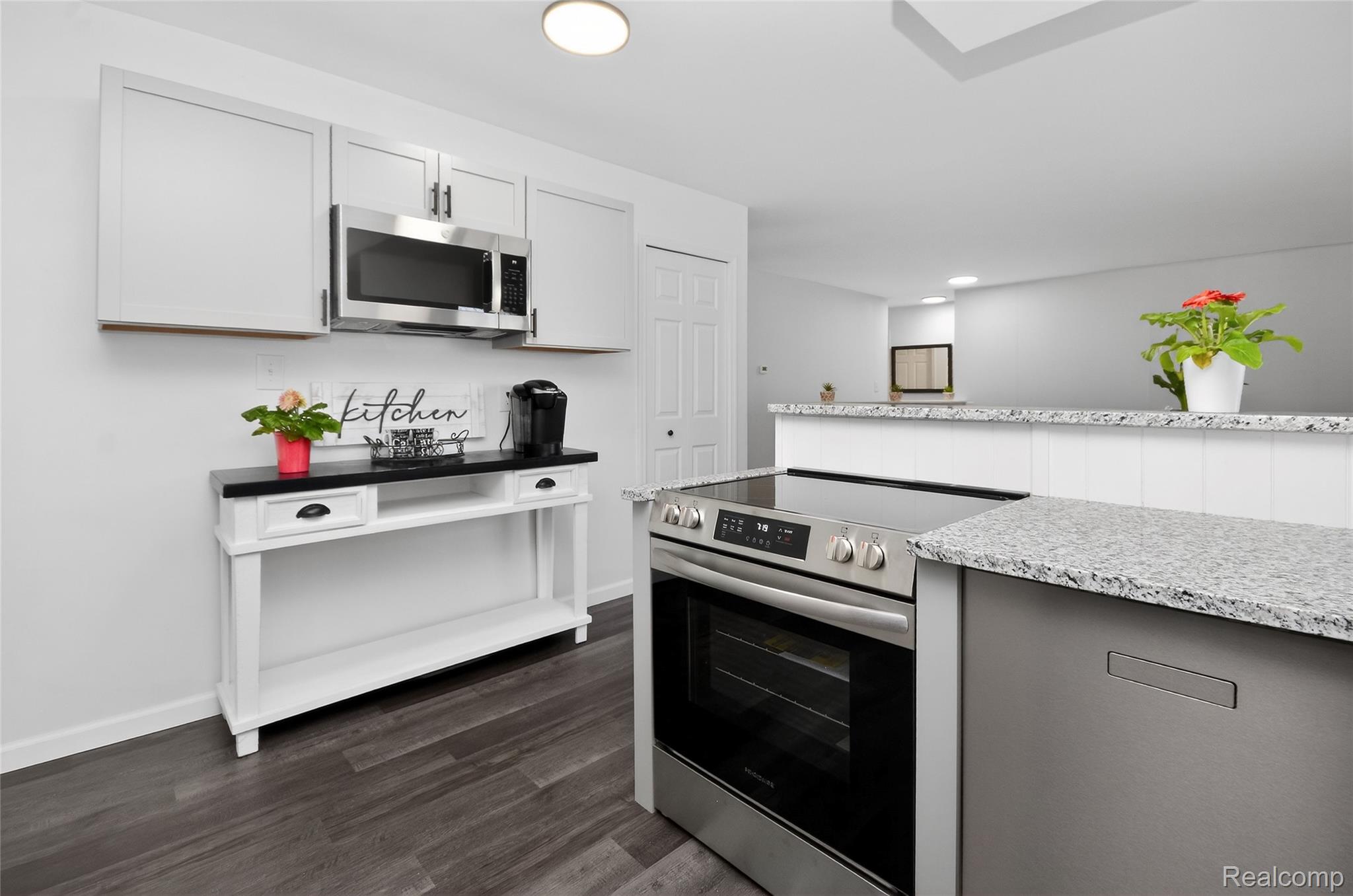 24065 Rockingham Street Southfield, MI 48033 - Photo 13 of 35 Kitchen with stainless steel appliances, dark wood-style floors, light stone counters, and gray cabinetry