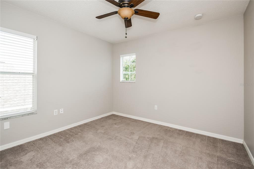 1170 Creekview Court St. Cloud, FL 34772 - Photo 13 of 17 an empty room with a window and a ceiling fan