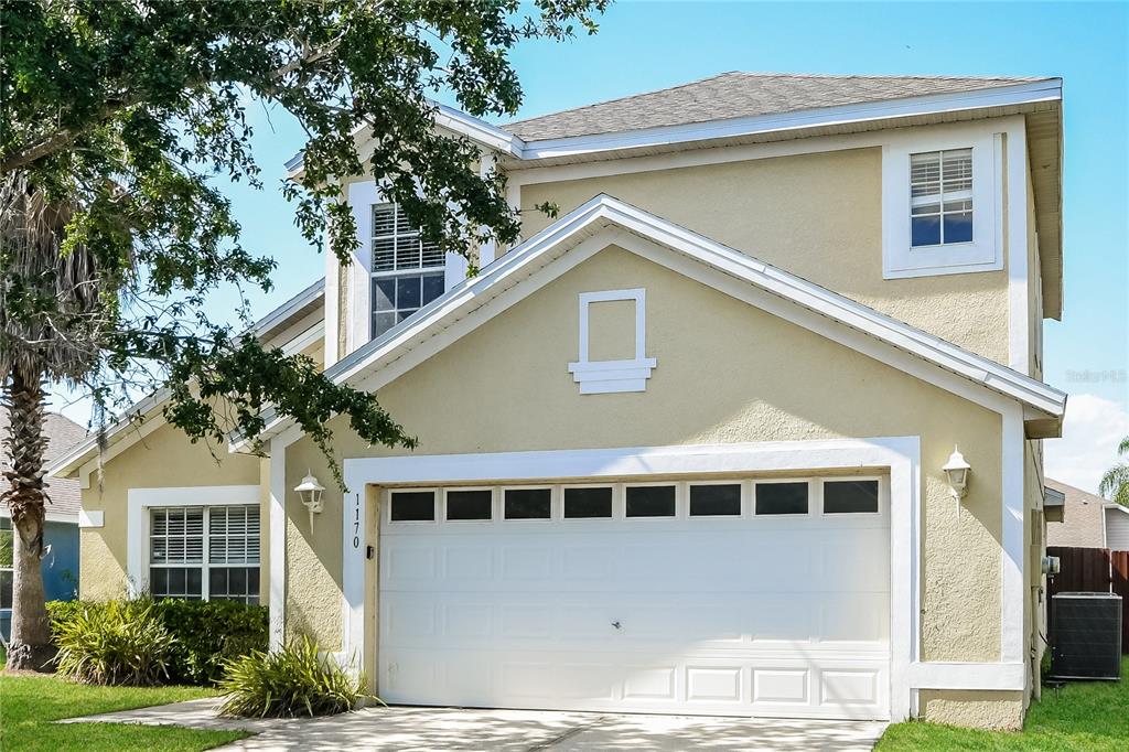 1170 Creekview Court St. Cloud, FL 34772 - Photo 2 of 17 a front view of a house with a yard