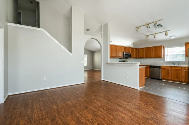 a view of a kitchen with a sink and wooden floor