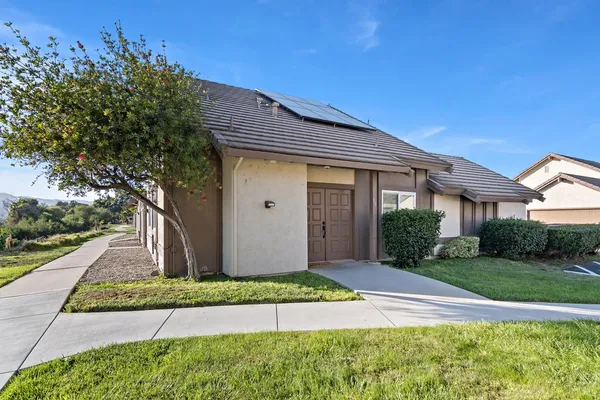 a front view of a house with a yard