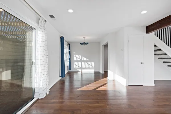 a view of an entryway with wooden floor