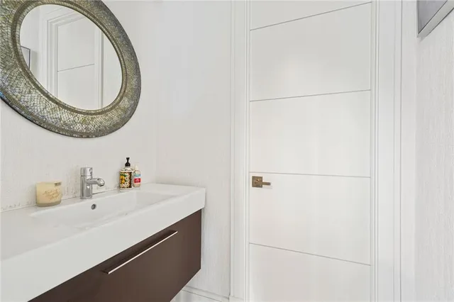 a view of a white house with large windows and table