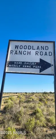 a sign board with water in the background