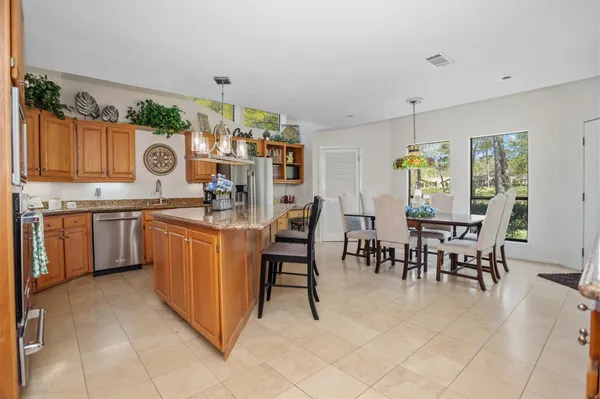 a kitchen with stainless steel appliances granite countertop a stove top oven a sink dishwasher and cabinets