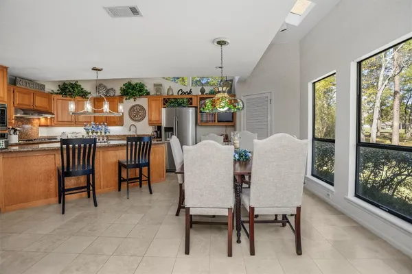 a view of a dining room with furniture and chandelier