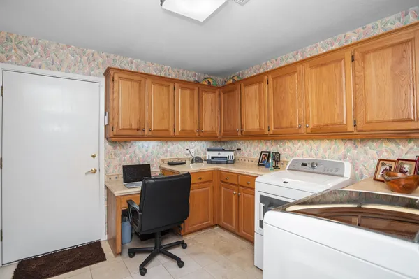 a view of a kitchen with sink and cabinets