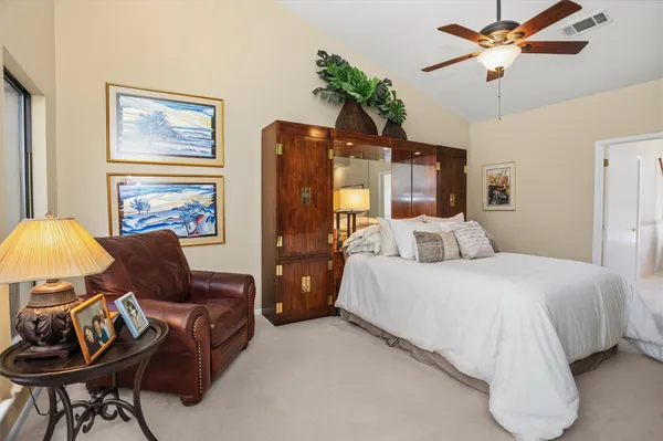 a bedroom with furniture and a chandelier