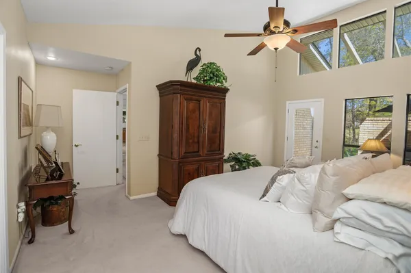 a bedroom with a bed and a mirror