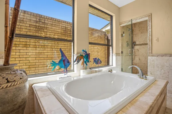 a bathroom with a tub sink and a mirror