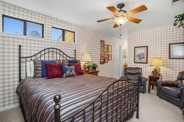 a bedroom with a bed a couch and dresser
