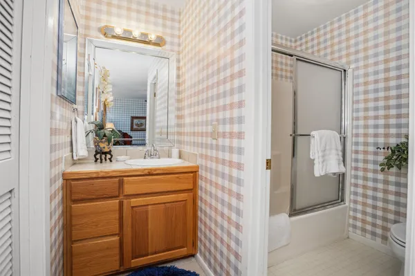 a bathroom with a sink a mirror and shower