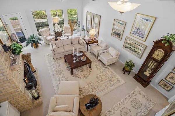 a living room with furniture and a floor to ceiling window