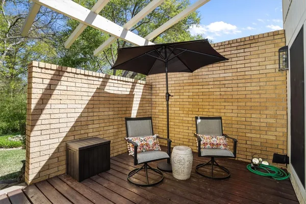 a backyard of a house with table and chairs