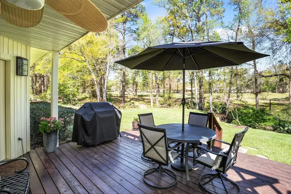 a view of balcony with furniture and umbrella