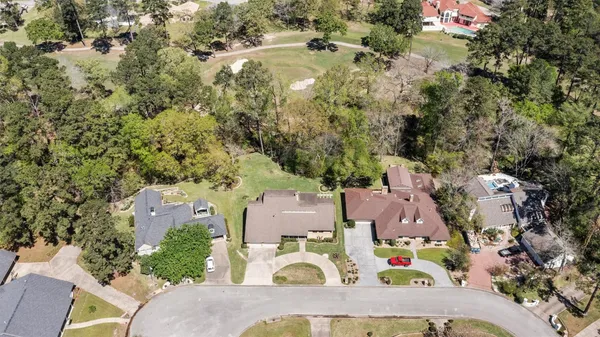 an aerial view of residential houses with outdoor space and parking