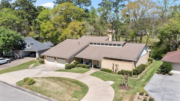 a aerial view of a house with a yard table and chairs