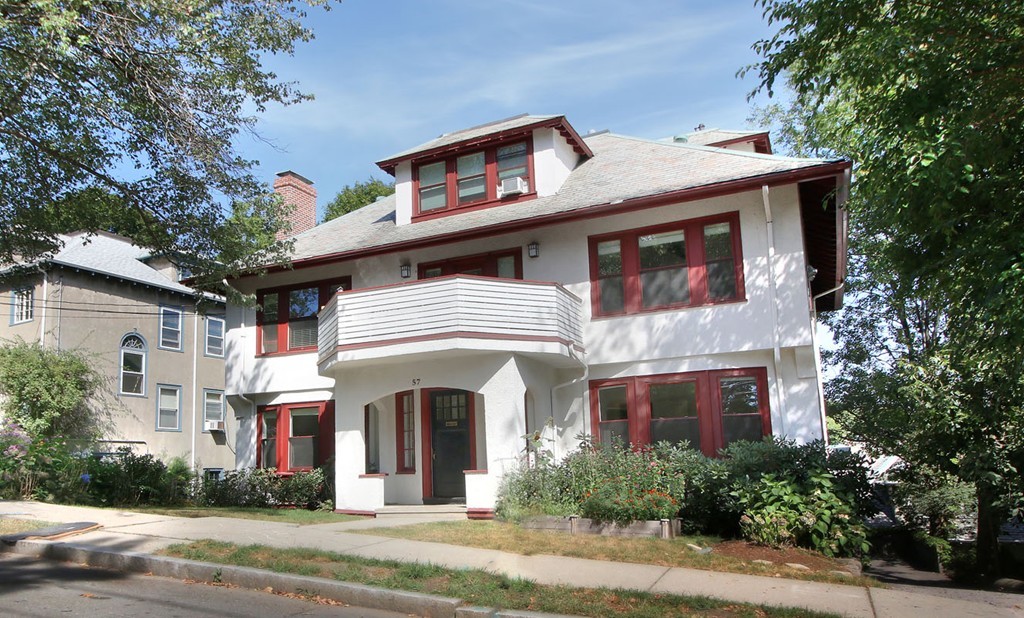 a front view of a house with a garden