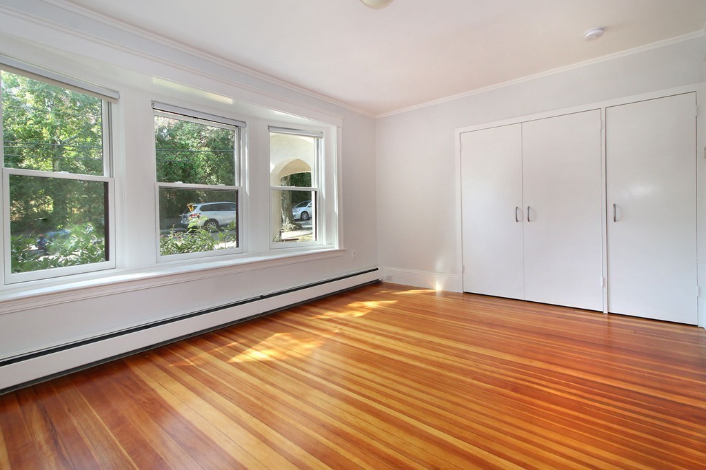 57 Winthrop Road, Unit 1 Brookline, MA 02445 - Photo 14 of 17 a view of an empty room with wooden floor and a window