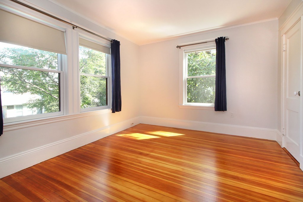 57 Winthrop Road, Unit 1 Brookline, MA 02445 - Photo 15 of 17 a view of an empty room with wooden floor and a window