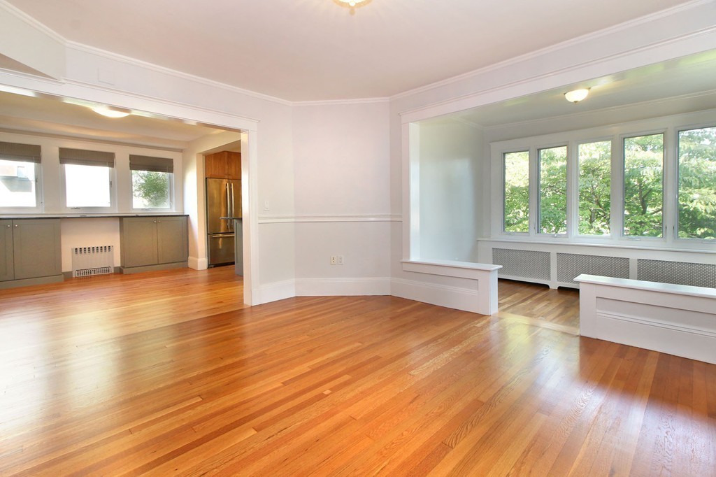 57 Winthrop Road, Unit 1 Brookline, MA 02445 - Photo 3 of 17 an empty room with wooden floor and windows