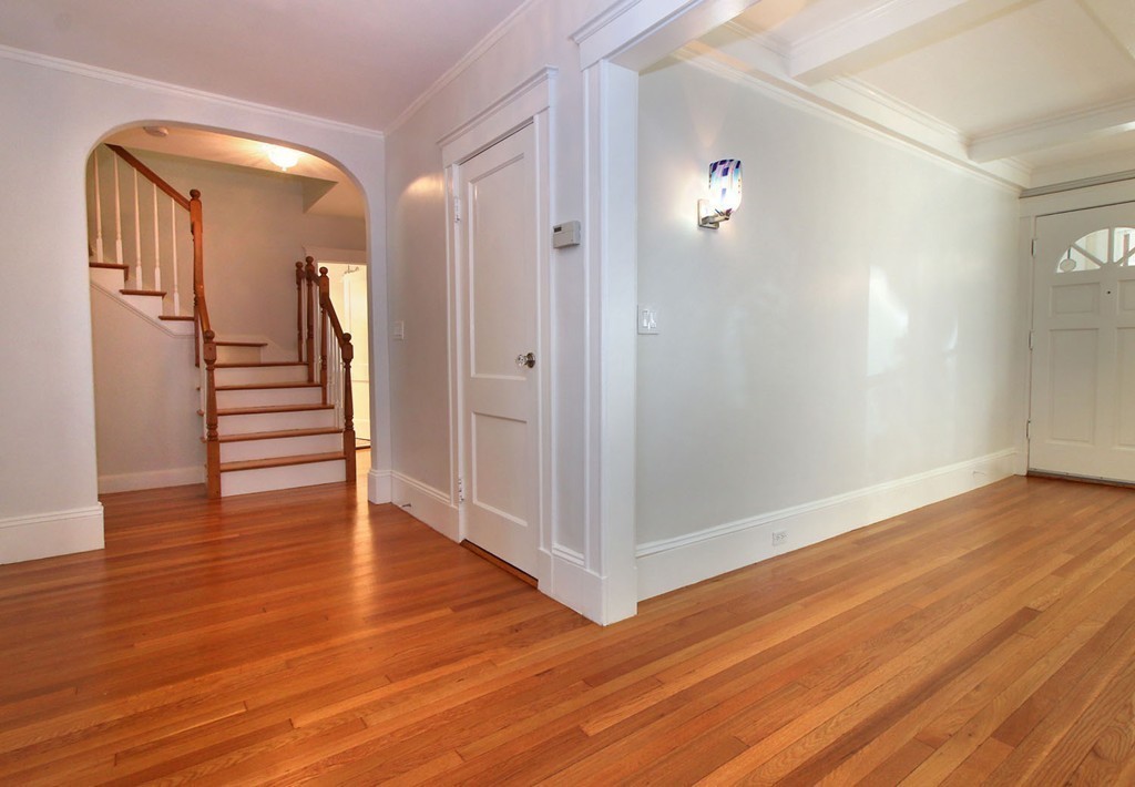 57 Winthrop Road, Unit 1 Brookline, MA 02445 - Photo 4 of 17 a view of a hallway with wooden floor and stairs