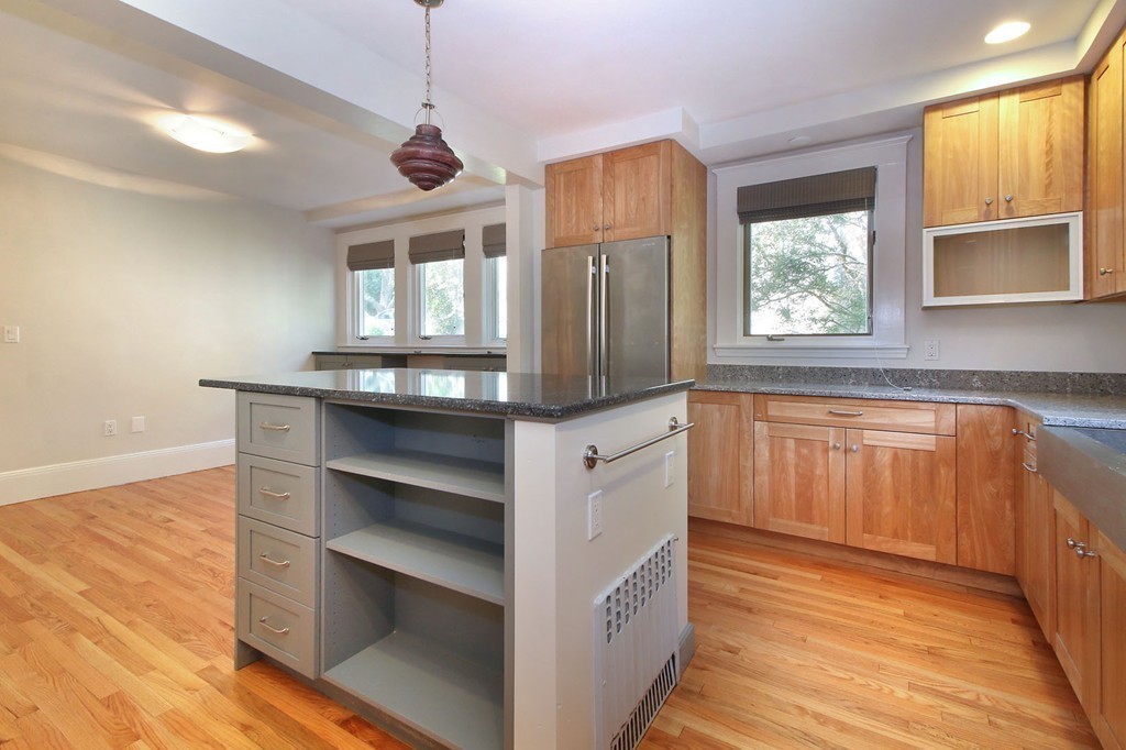 57 Winthrop Road, Unit 1 Brookline, MA 02445 - Photo 6 of 17 a kitchen with stainless steel appliances granite countertop a stove and a wooden floors
