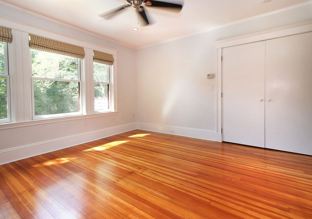 57 Winthrop Road, Unit 1 Brookline, MA 02445 - Photo 8 of 17 a view of an empty room with wooden floor and a window