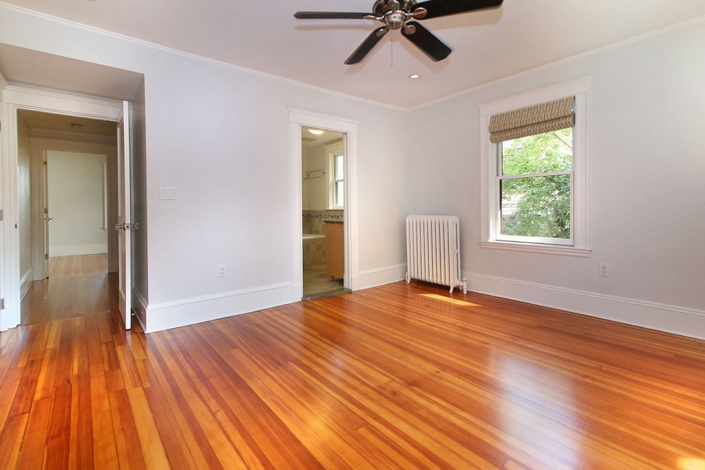 57 Winthrop Road, Unit 1 Brookline, MA 02445 - Photo 10 of 17 a view of empty room with wooden floor and fan