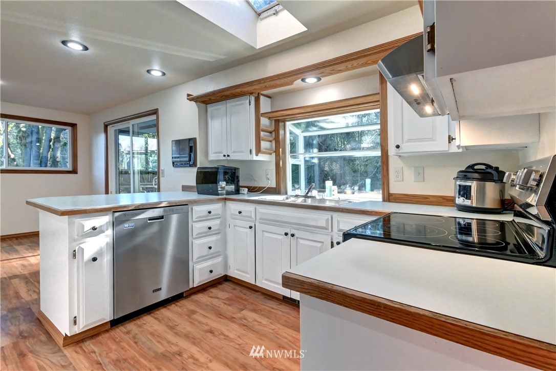 15220 OK Mill Road Snohomish, WA 98290 - Photo 4 of 26 a kitchen with a sink stove and cabinets