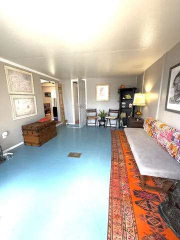 a living room with furniture pool table and a window