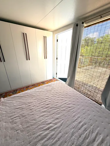 a living room with a bed furniture and a window