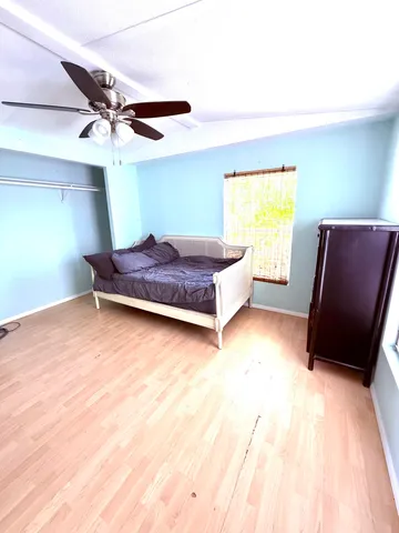 a bedroom with a bed and a window