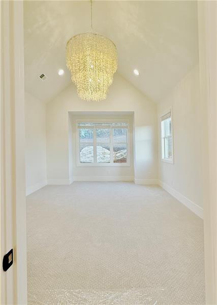 122 Palisade Drive Rydal, GA 30171 - Photo 31 of 54 an empty room with a chandelier fan and wooden floor