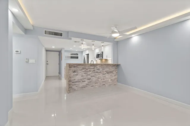 a view of kitchen and hall with wooden floor