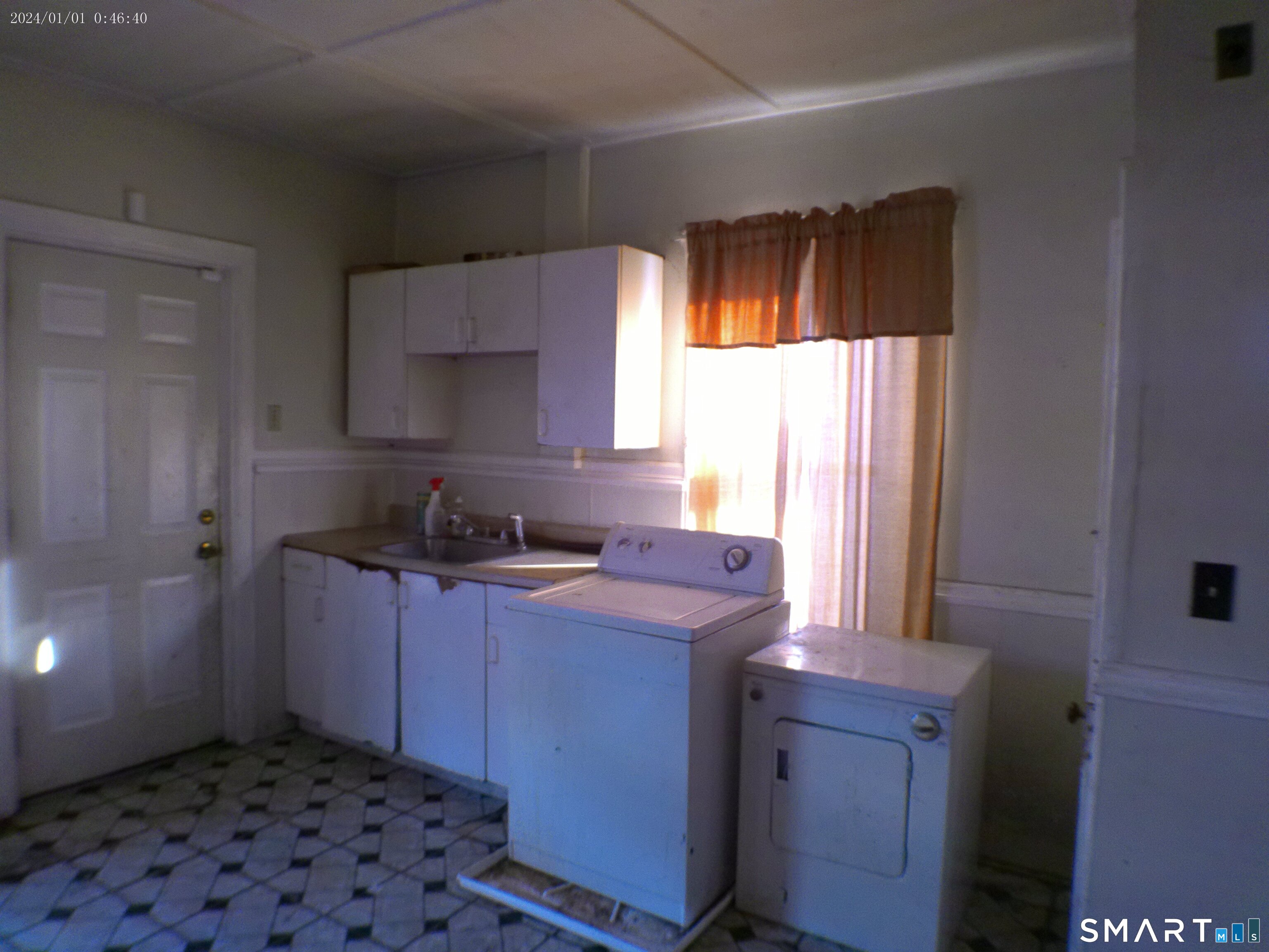 a kitchen with a sink window and cabinets