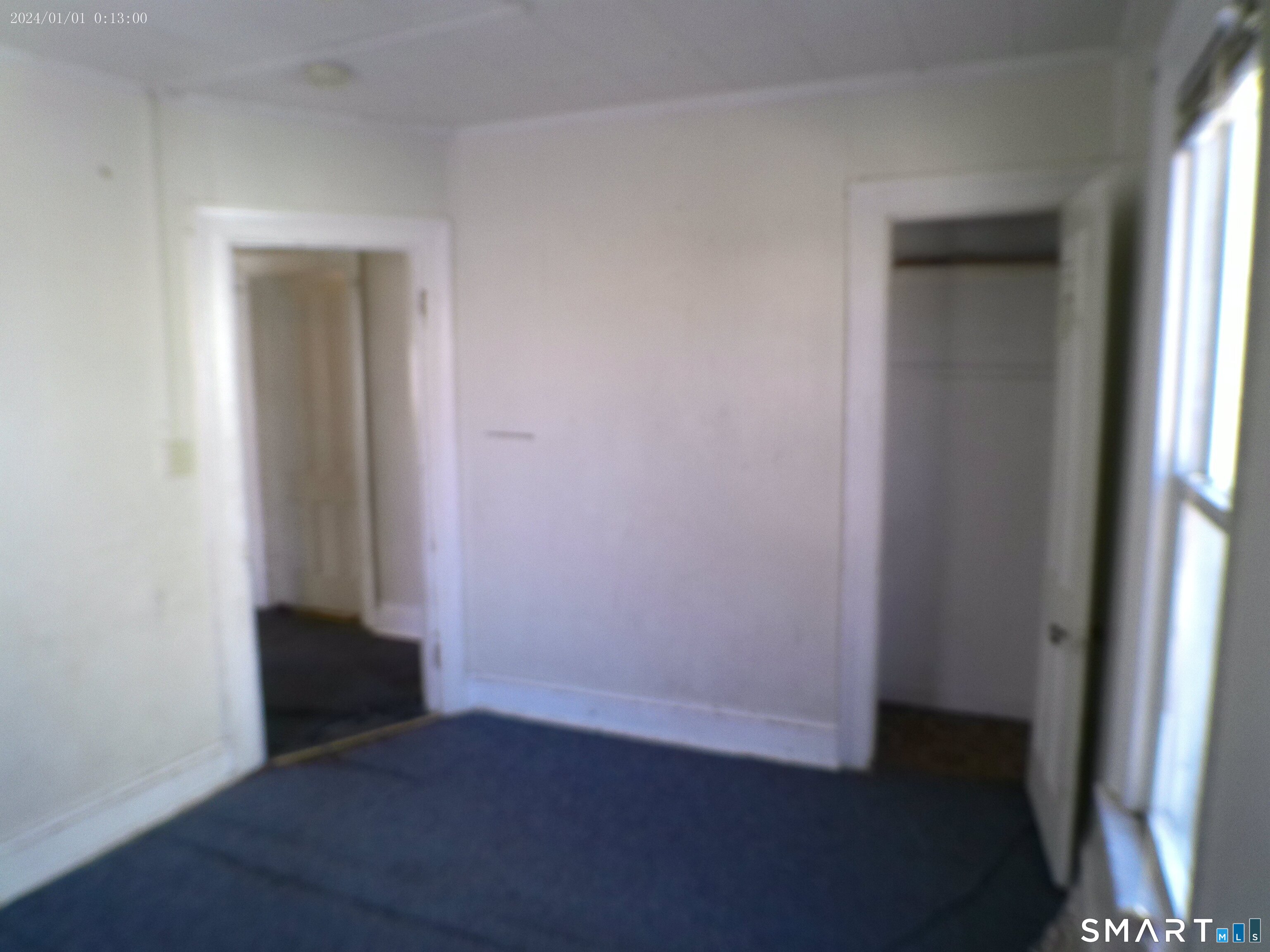 306 Carroll Avenue Bridgeport, CT 06607 - Photo 5 of 15 an empty room with wooden floor and a window