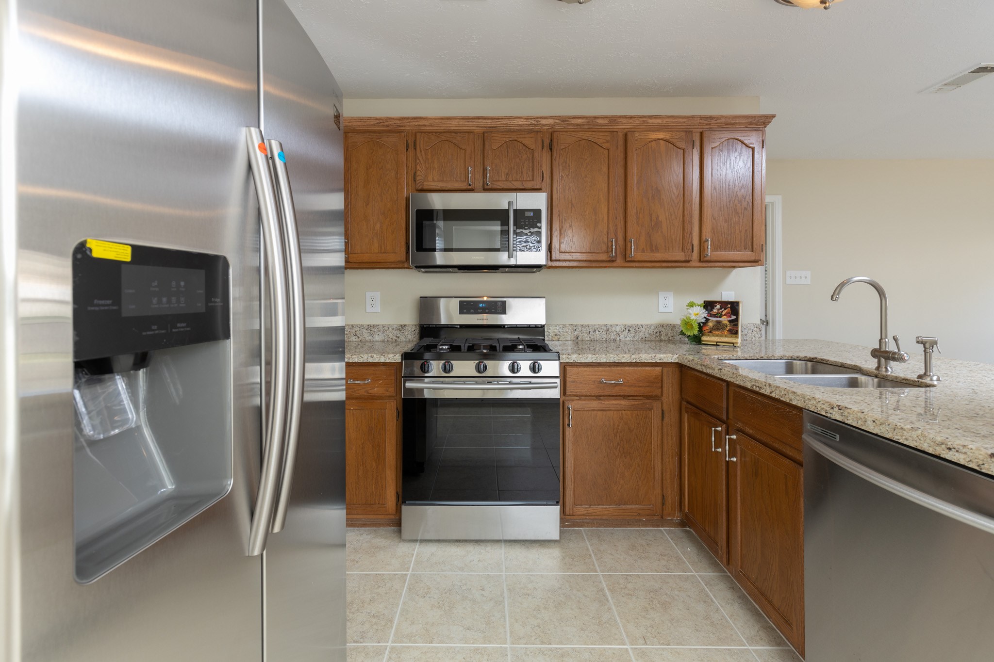 3422 Keygate Drive Spring, TX 77388 - Photo 11 of 32 a kitchen with stainless steel appliances granite countertop a refrigerator and a stove top oven