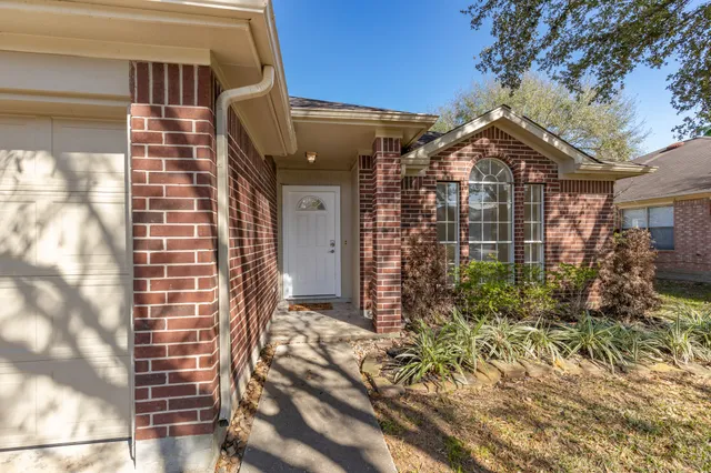 a view of a brick house with windows
