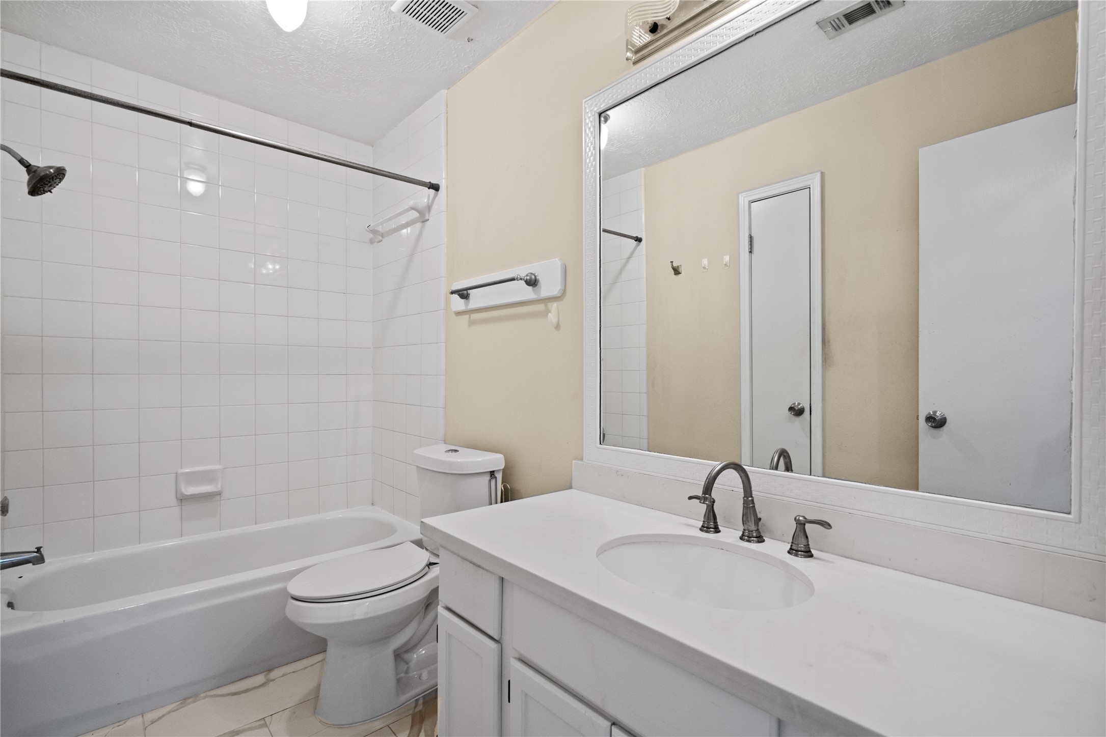 3422 Keygate Drive Spring, TX 77388 - Photo 25 of 32 a bathroom with a toilet a sink a mirror a bathtub and shower
