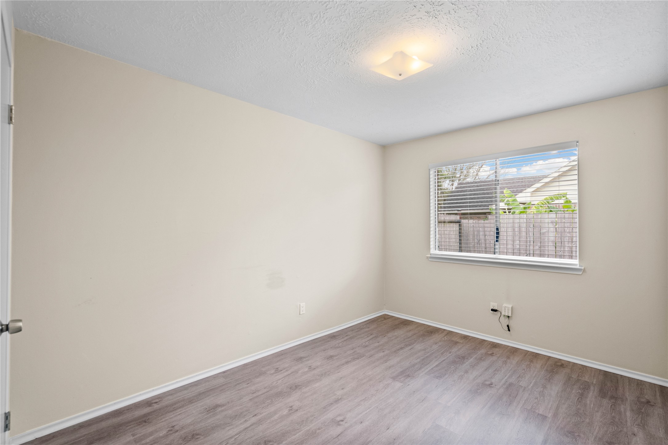 3422 Keygate Drive Spring, TX 77388 - Photo 26 of 32 wooden floor in an empty room with a window