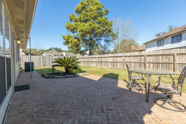 a view of a house with snow on the side of the road