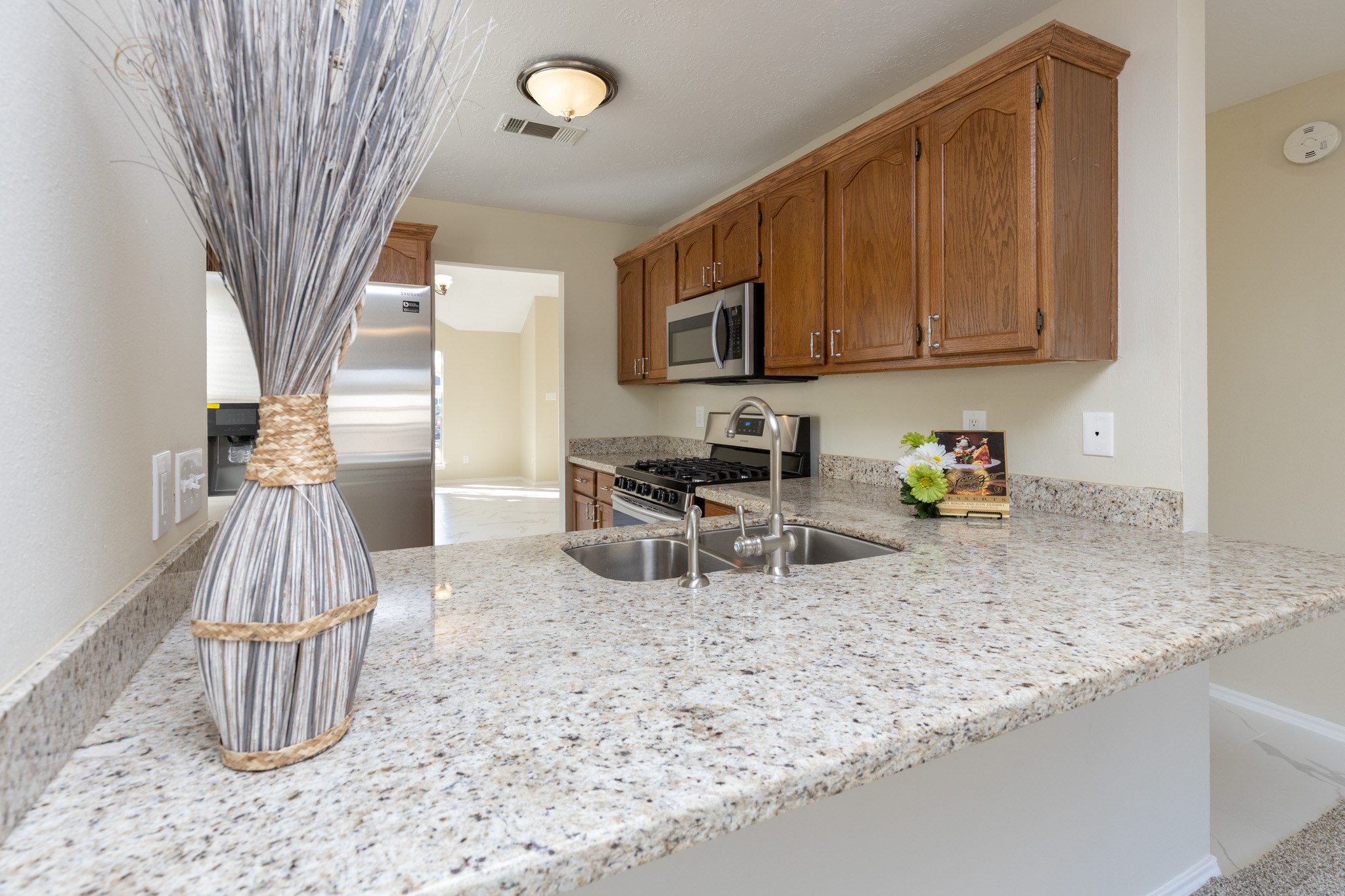 3422 Keygate Drive Spring, TX 77388 - Photo 8 of 32 a kitchen with a sink a stove and a wooden cabinets