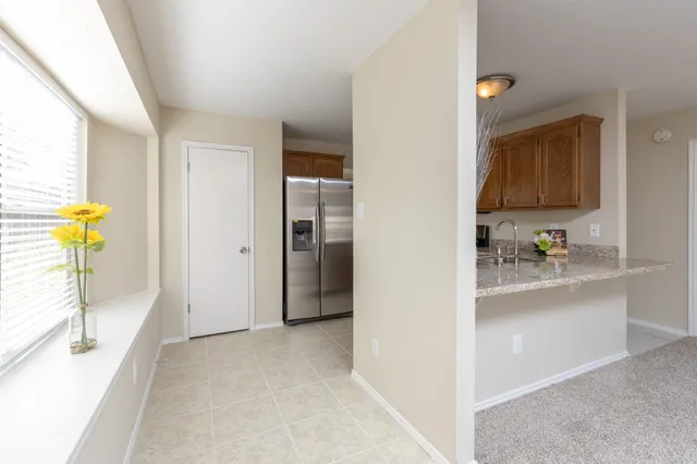 a kitchen with stainless steel appliances granite countertop a refrigerator and a stove top oven