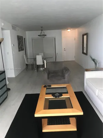 a room with pool table and a rug