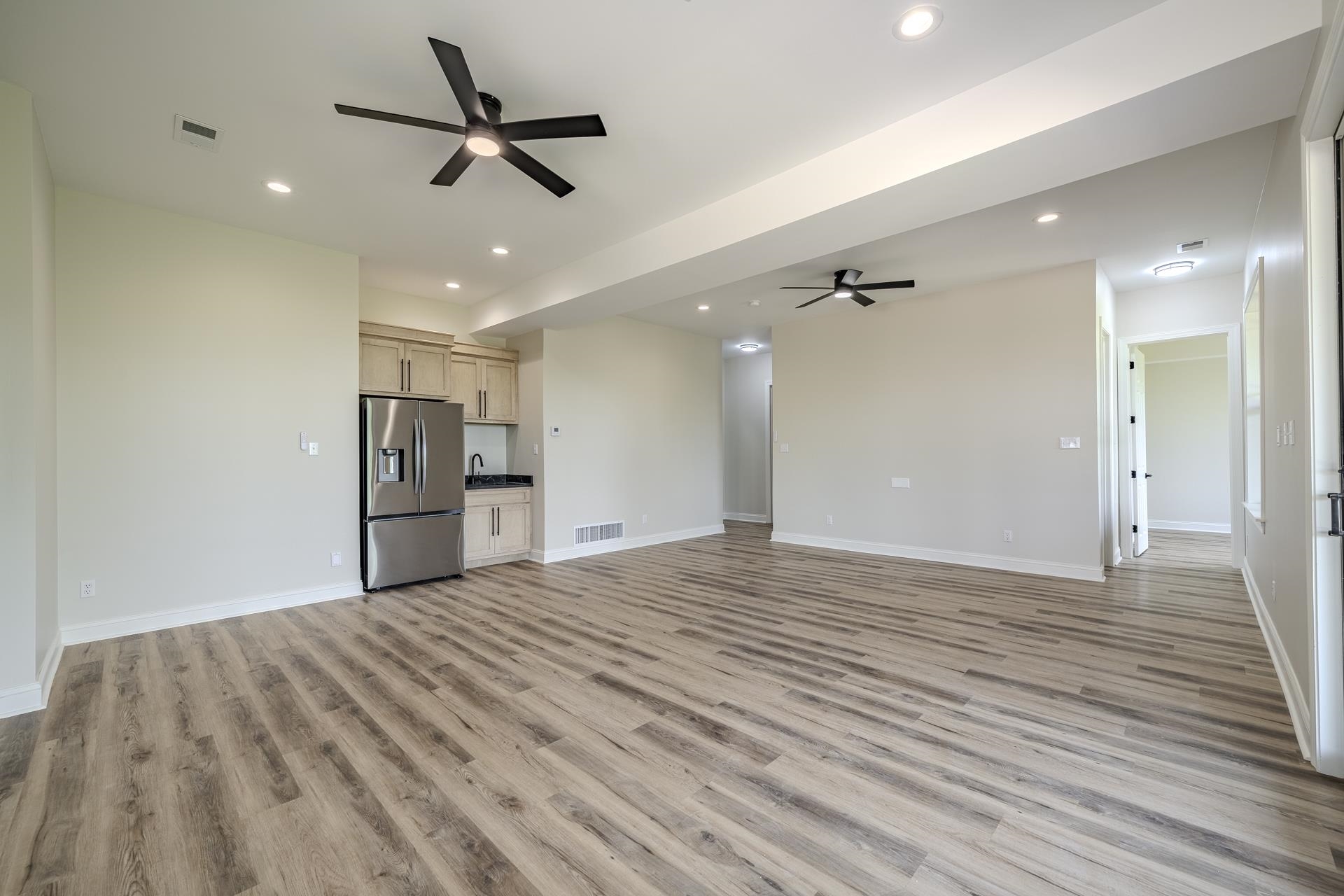851 Rivers Edge Drive Bath Springs, TN 38311 - Photo 26 of 39 Spacious room featuring wood-finish flooring, recessed lighting, and modern ceiling fans