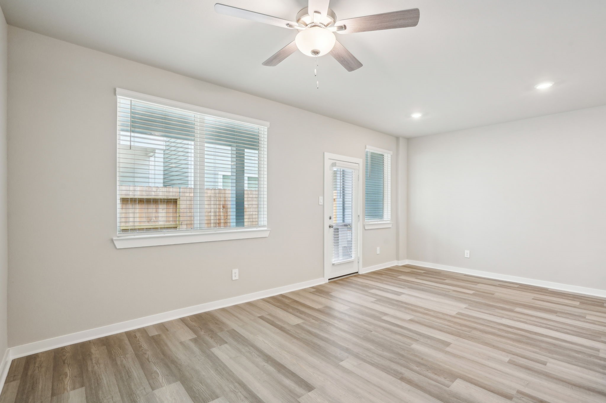 3119 Quiet Sunset Drive Houston, TX 77080 - Photo 11 of 46 a view of an empty room with wooden floor and a window