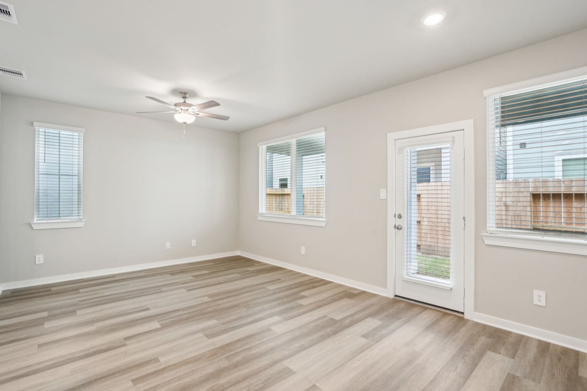 3119 Quiet Sunset Drive Houston, TX 77080 - Photo 12 of 46 a view of an empty room with a window and wooden floor