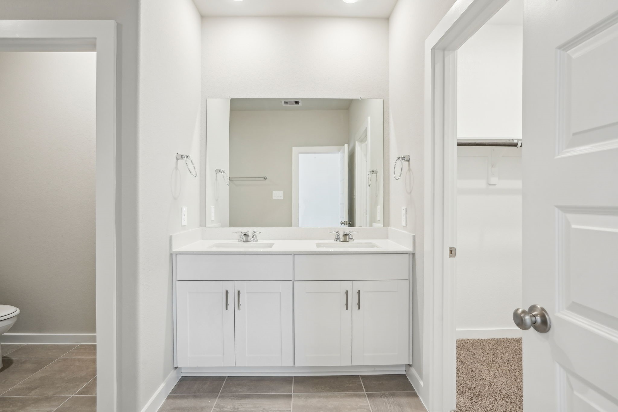 3119 Quiet Sunset Drive Houston, TX 77080 - Photo 25 of 46 a bathroom with a double vanity sink and mirror