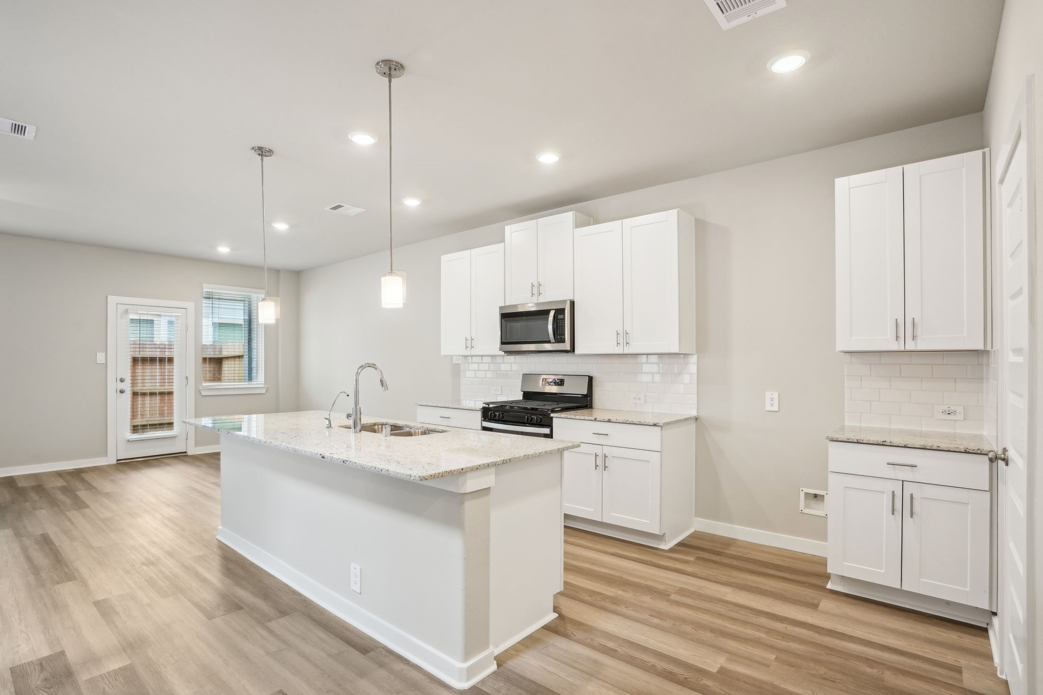 3119 Quiet Sunset Drive Houston, TX 77080 - Photo 4 of 46 a kitchen with white cabinets and sink
